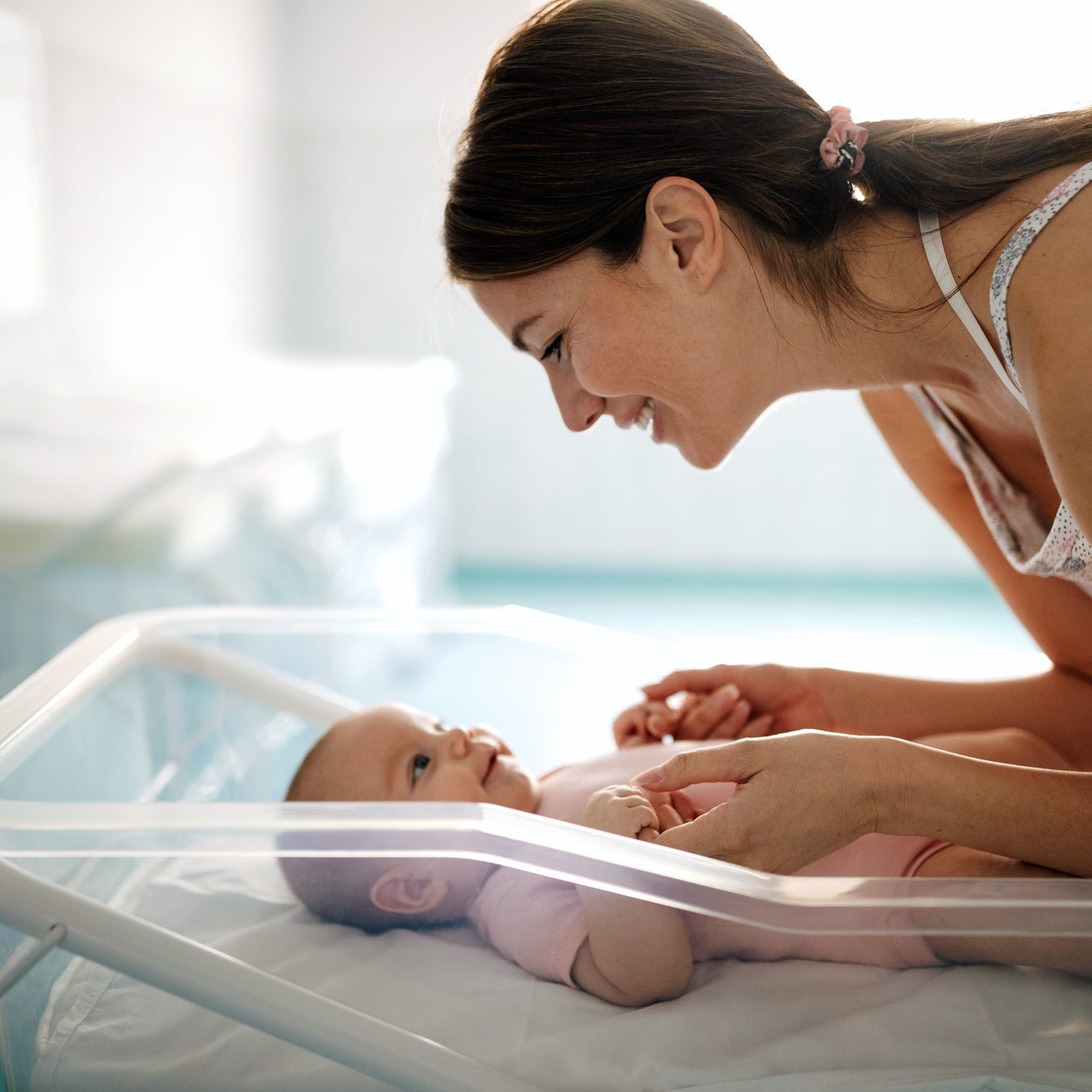 Mother holding her newborn baby child after labor in a hospital