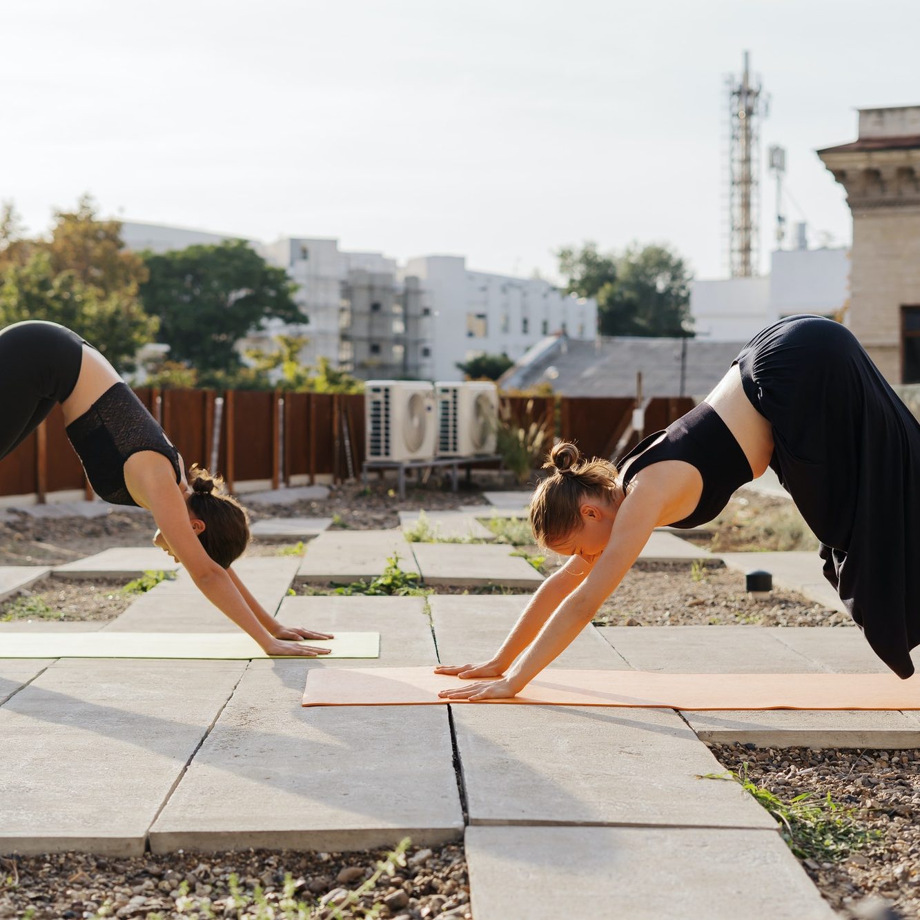 Two young girls practicing stretching and yoga workout exercise together